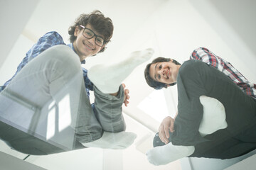 Low angle of father and sons sitting on glass