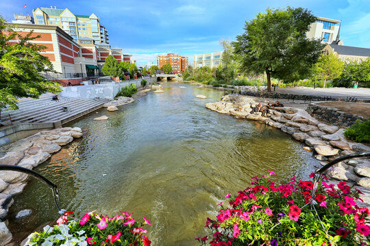 RENO, USA - AUGUST 12: Apartment buildings along Truckee river on August 12, 2014 in Reno, USA. Reno is the most populous Nevada city outside of the Las Vegas.