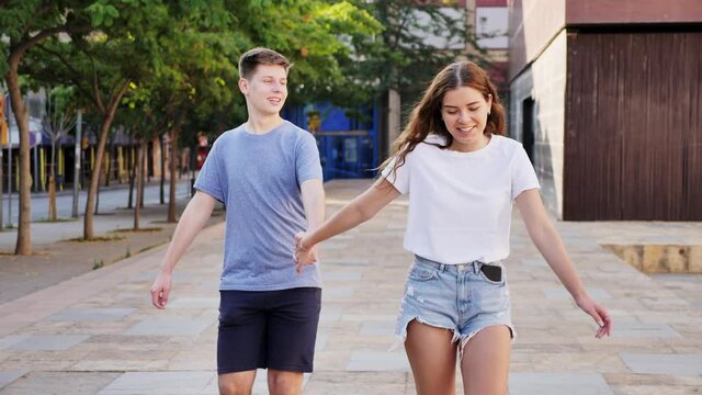 Young girl is walking and young man is following her