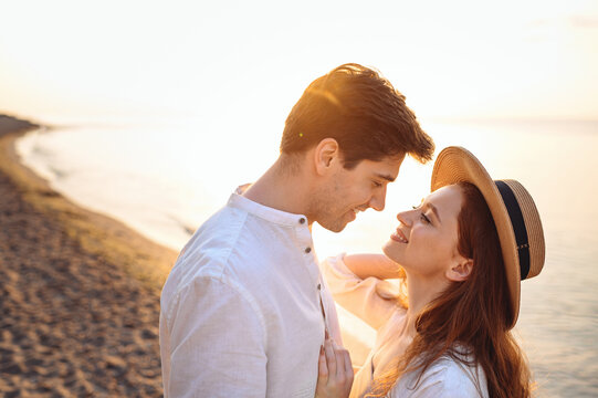 Close Up Profile Young Happy Tender Couple Two Friends Family Man Woman In White Clothes Hug Going To Kiss Together At Sunrise Over Sea Beach Ocean Outdoor Exotic Seaside In Summer Day Sunset Evening.