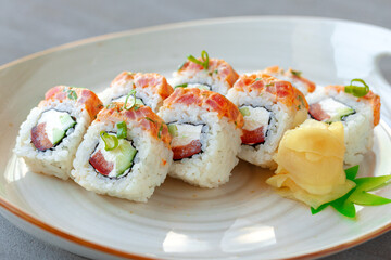 Japanese sushi roll with salmon on plate