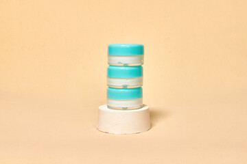 Cosmetics container on the pastel background. Earth colors, zero waste containers. Mockup concept. Minimal boxes and geometric podium. Scene with geometrical forms. 