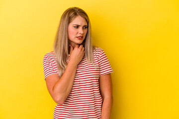 Young russian woman isolated on yellow background suffers pain in throat due a virus or infection.