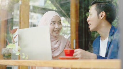 Upwardly mobile Asian Muslim business entrepreneur SME start up group of young man and women, discussing sale and marketing analysis, Asian Muslim SME teamwork e-commerce concept
