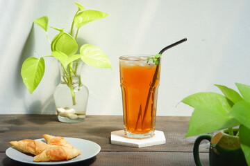 a glass of iced tea on the table 