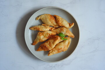 a plate of fried banana pastry named molen pisang 