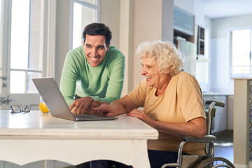 Obraz premium Senior woman has fun streaming video on her laptop computer