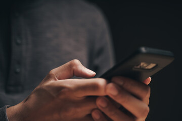 Closeup of a man using a smartphone on the wooden table, searching, browsing, social media, message, email, internet digital marketing, online shopping..