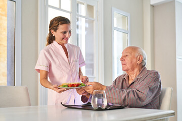 Senior is provided with lunch by the delivery service