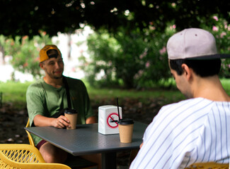 mixed race friends eating together street food sitting at the table