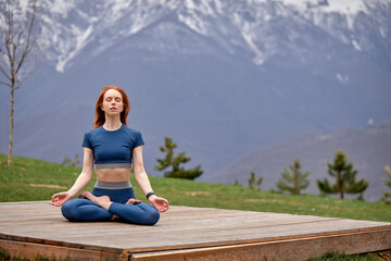 Naklejka na ściany i meble Yoga Life Balance Woman Exercise. Fit Female practicing yoga pose, keep balance, body vital zen meditation in nature, mountains Landscape outdoor in the background. Healthy lifestyle