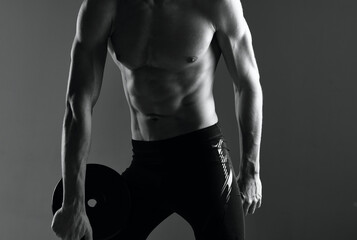 man with pumped up abs exercises motivation dark background