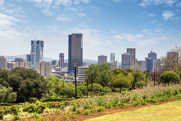 Fototapeta na wymiar Pretoria cityscape across the parklands of the Union Buildings. Pretoria is one of South Africa's three capital cities and is the administrative capital.
