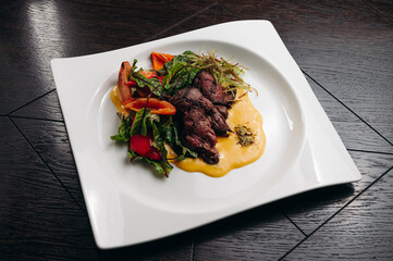 grilled beef tenderloin fillet with salad and sauce