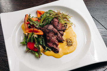 grilled beef tenderloin fillet with salad and sauce