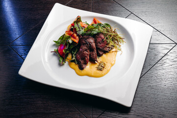 grilled beef tenderloin fillet with salad and sauce