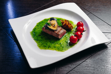 Grilled tuna steak with vegetable with cherry tomatoes, mussel and sauce