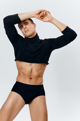 Fototapeta na wymiar sexy guy with a pumped up torso and cubes on the belly bodybuilder panties sweater model