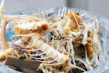 A small pile of fish bones and leftover food in close-up. Food waste