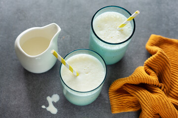 Milkshake in glasses on bright background