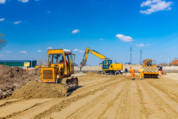 Obraz premium Bulldozer machine is leveling construction site.