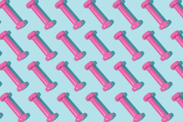 Pink dumbbell pattern on blue background. Sport and exercise. 