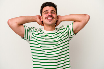 Young caucasian man isolated on white background stretching arms, relaxed position.