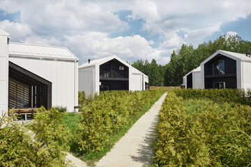 Wide angle background image of houses designed with minimal Scandinavian aesthetic in black and white colors, copy space