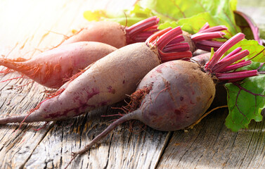 Red Beets on wooden rustic background. Organic Beetroot.