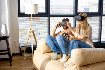Joyous caucasian couple playing video games with television in new apartment. excited and funny for amazing experience in new video game at lving room. Relax and hobby concept. Side view, copy space