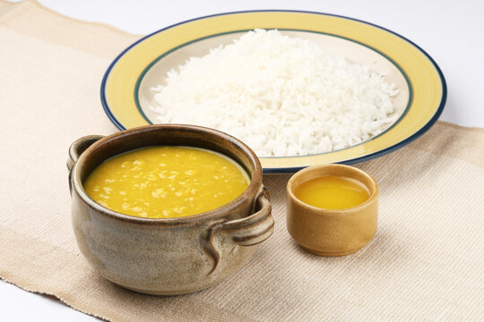 Indian staple food everyday meal Dal Rice or yellow lentil soup with white rice and ghee also called dal chaval & varan bhat