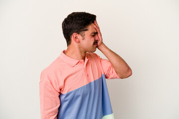 Young caucasian man isolated on white background having a head ache, touching front of the face.