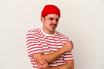 Young caucasian man isolated on white background suspicious, uncertain, examining you.