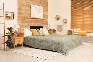 Stylish room interior with big comfortable bed