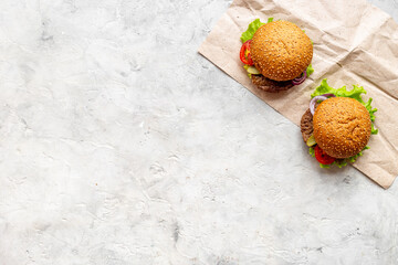 Burgers with beef meat steak on stone table, top view