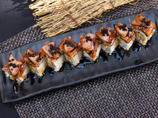 Unagi foie gras Sushi rolls- japanese food style on black background.