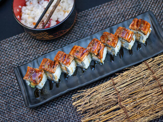 Unagi Sushi rolls- japanese food style on black background.