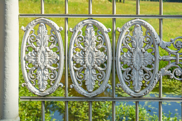 Historical vintage white cast iron lattice fence, ellipse decorative ornamets