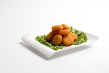 deep fried crispy golden scallops or chicken or fish nugget salad in white black  background dim sum snack halal menu