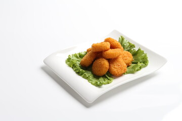 deep fried crispy golden scallops or chicken or fish nugget salad in white black  background dim sum snack halal menu