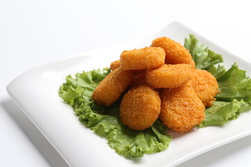 deep fried crispy golden scallops or chicken or fish nugget salad in white black  background dim sum snack halal menu