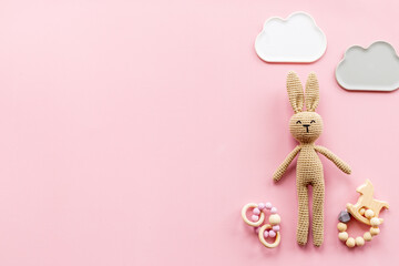 Knitted baby toy rabbit for newborn with wooden toys, top view