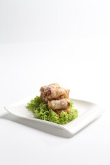 crispy deep fried bacon roll meat in white black background dim sum snack halal menu