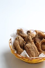 deep fried crispy chicken meat in basket in white black background dim sum snack halal menu