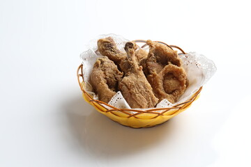 deep fried crispy chicken meat in basket in white black background dim sum snack halal menu