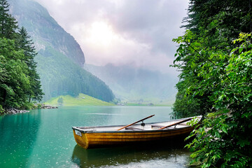 Naklejka na ściany i meble Natural landscap of the mountain lake in the .Switzerland. Boat on the mountain lake