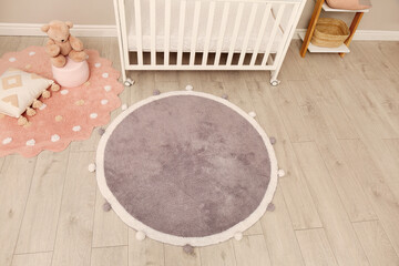 Baby room interior with modern furniture and soft rug, above view