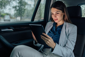 Adult woman, checking her messages, in the car.