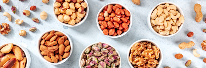 Nut assortment panoramic header. Healthy vegan snack banner with almonds and peanuts