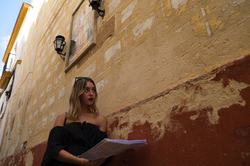 Portrait of a beautiful young woman. The woman is on holiday and is holding a map of the city she...